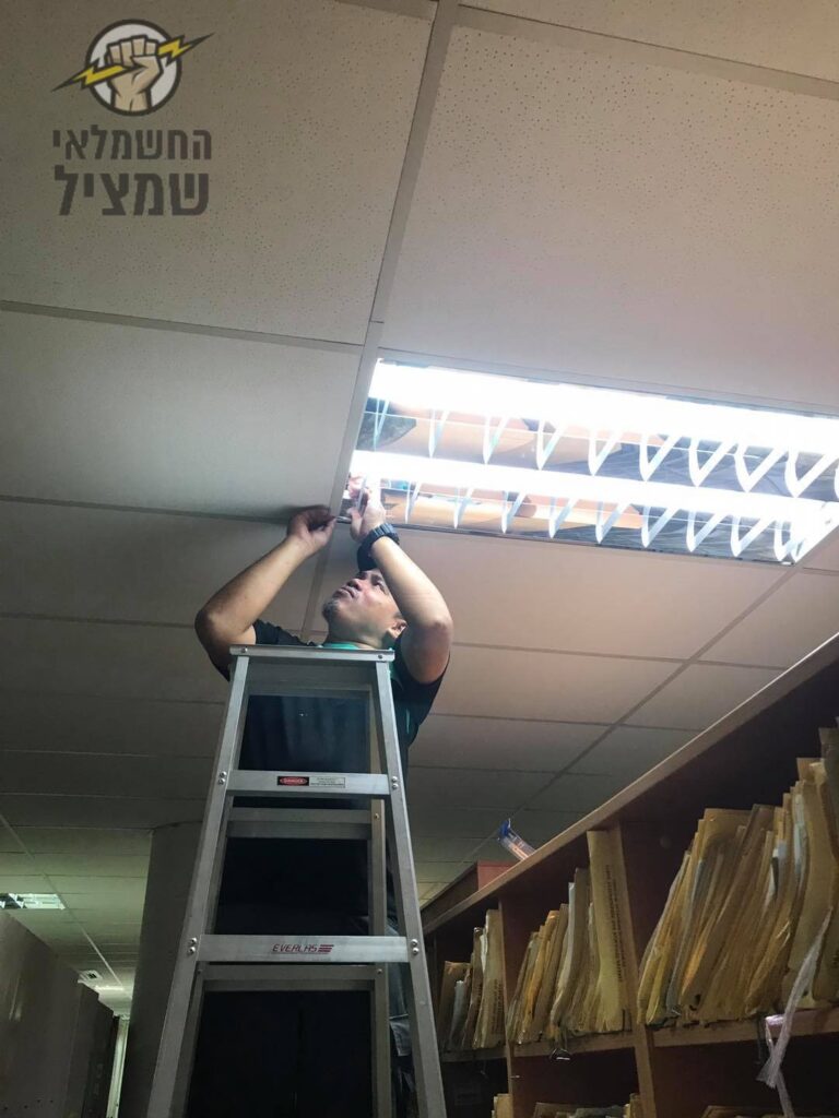 חשמלאי מרמלה מתקין תאורה בתקרה אקוסטית במשרד